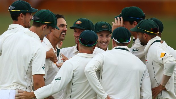 Johnson celebrates the wicket of Tom Latham with teammates.