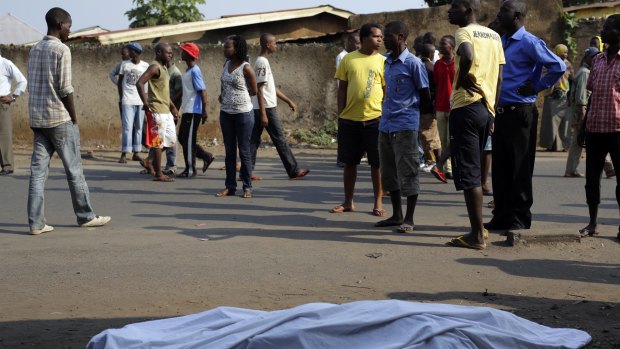 The body of a man lies on a street in Bujumbura as polls open on Tuesday.