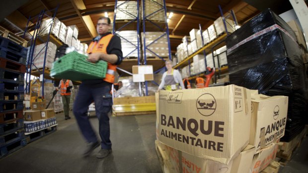 Volunteers at the Banques Alimentaire (Food Bank) move palettes in their warehouse in Arcueil, France last month.