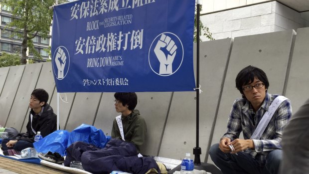 Students on a hunger strike oppose Japanese Prime Minister Shizo Abe outside the parliament in Tokyo on Friday.