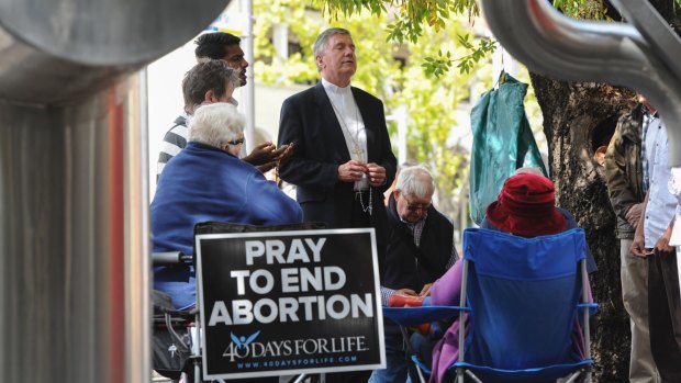 Canberra Goulburn Catholic Archbishop Christopher Prowse leads a vigil outside Civic's abortion clinic last year.