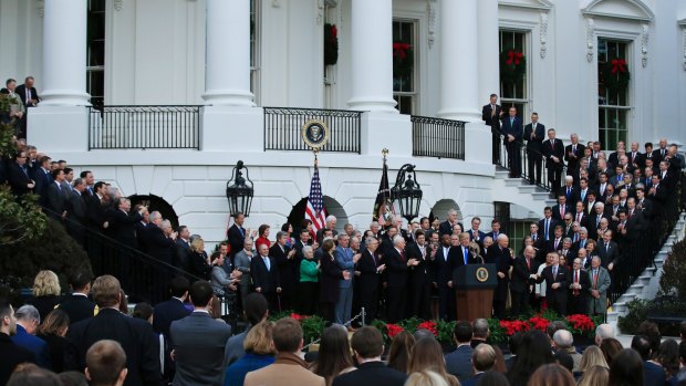 Full house: Congress members and staff line the stars of the White House as part of the tax-bill celebrations.