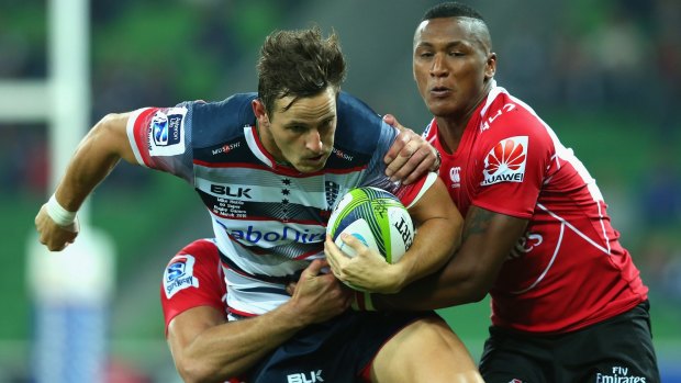 Mike Harris of the Rebels is tackled by Sampie Mastriet of the Lions  during the round six Super Rugby match on Friday.