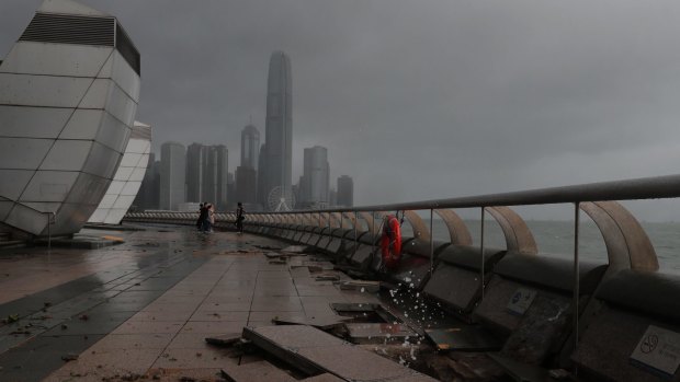 Debris caused by typhoon Hato damage is strewn across the waterfront of Victoria Habour in Hong Kong on Wednesday.