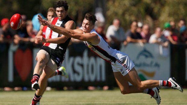 Paddy McCartin kicks as Dylan Roberton attepts to smother during a St Kilda intra-club match on Saturday.