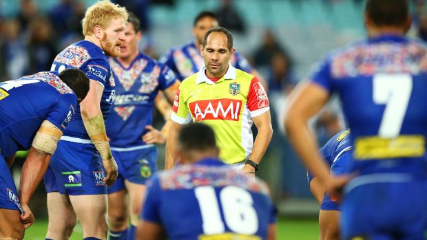 Wild Dogs: Referee Ashley Klein is surrounded by Bulldogs players after disallowing a try to Josh Reynolds in extra time.
