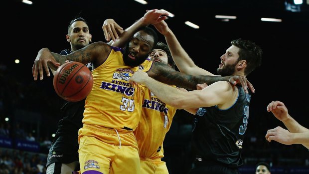Tough night: Kings debutant Damion James is blocked by duo Tai Wesley and Alex Pledger. 