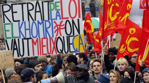 Students march in Paris with a sign that reads: "Cancel the law El Khomri". 