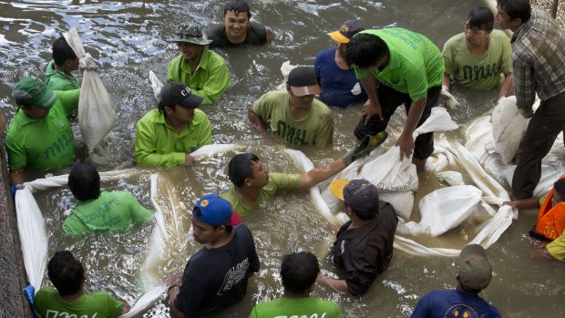 Workers build a dam from sandbags last month as they attempt to seal off a canal to search for remnants of an explosive device thrown into the canal