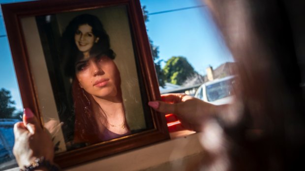 Tanille Mizzi's face is reflected in a photo of her mother Samantha, who was murdered in 1994.