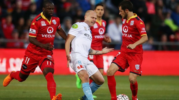 Aaron Mooy of Melbourne City loses the ball as he is tackled.