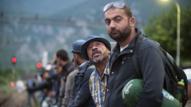 Migrants wait for a train in Demir Kapija, south-eastern Macedonia, on Thursday, in the hope of crossing the EU border into Romania, Hungary and Croatia. 