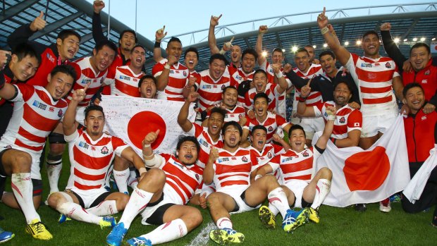 Cherry Blossoms in bloom: Japan players celebrate after defeating South Africa.