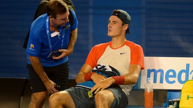 Flashback: Bernard Tomic speaks to the doctor during his match against Rafael Nadal at Rod Laver Arena in 2014.