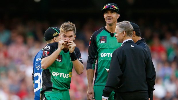 Adam Zampa holds his nose as he looks up at a replay of the bizarre run-out in which he was involved on Saturday night.