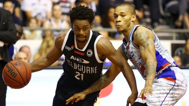 Melbourne United's Casper Ware drives to the basket against Jerome Randle of the Adelaide 36ers.