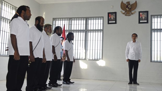 Indonesian President Joko Widodo (right) attends a ceremony to grant five political prisoners clemency at a prison in Jayapura, Papua province.