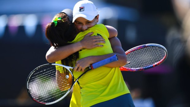 Casey Dellacqua and Ash Barty celebrate their decisive doubles win.