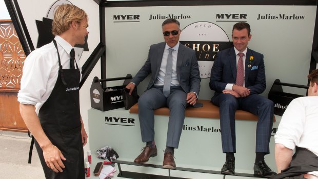 Ahmed Fahour (centre), taking advantage of a free shoe shine at the 2015 Melbourne Cup.  