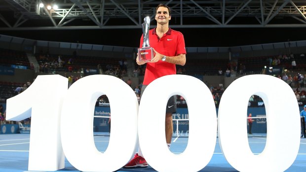 Twin peaks: Roger Federer holds his first Brisbane International trophy, achieved in his 1000th career match win.