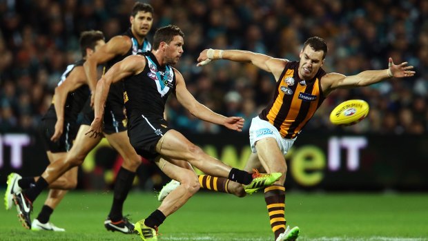 Travis Boak of the Power clears the ball from the centre during the match against Hawthorn on Saturday.