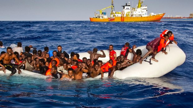 Migrants ask for help as they are approached by the SOS Mediterranee's ship Aquarius in April 2016.