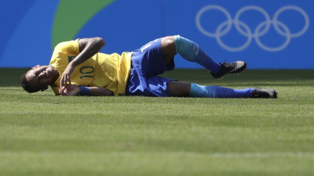 Brazil's Neymar grimaces in pain after the goal.