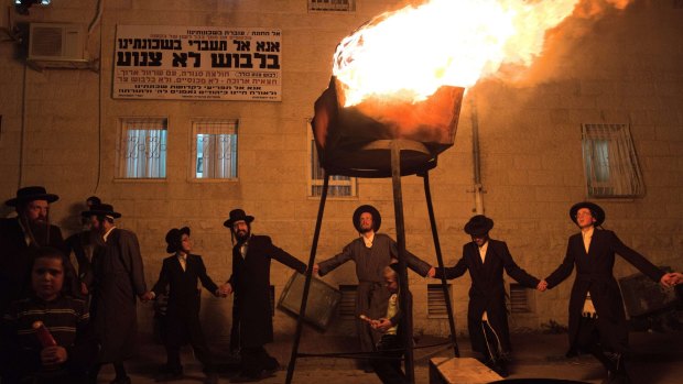 Ultra-Orthodox Jewish men dance around a bonfire in the Mea Shearim neighbourhood of Jerusalem on Wednesday to mark the religious holiday of Lag BaOmer. Ultra-Orthodox parties will return to Israel's government as part of the coalition deal.