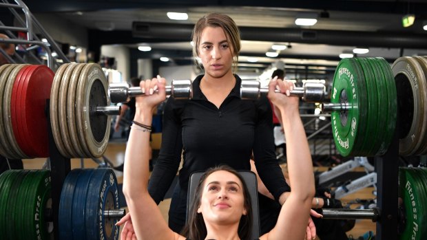 Personal trainer Alev Basarin training her client Elise Wood in Melbourne on Monday. 