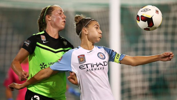 Steph Catley of Melbourne City and Celeste Boureille of Canberra compete for the ball.