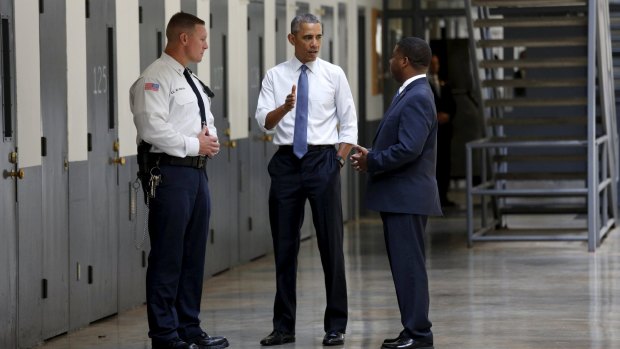 President Obama speaking Bureau of Prisons Director Charles Samuels and correctional officer Ronald Warwick. 