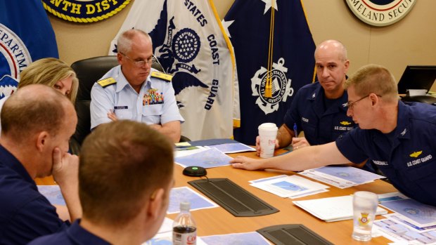 Rear Admiral Scott Buschman, commander of the Coast Guard 7th District in Miami, receives an update briefing for the missing cargo ship El Faro.
