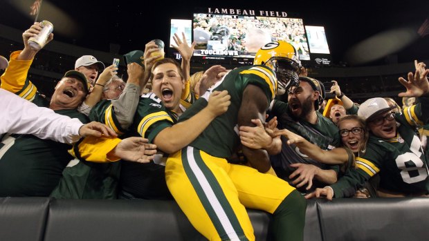Spectacular: James Jones celebrates with fans after scoring a touchdown thrown by Green Bay quarterback Aaron Rodgers against the Seattle Seahawks during their game at Lambeau Field.