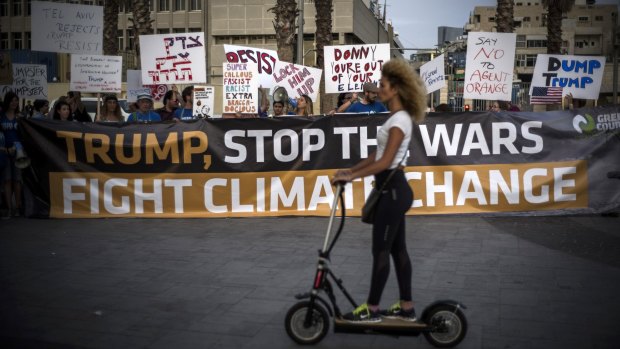 People protest against US President Donald Trump's visit to Israel in Tel Aviv on Monday.
