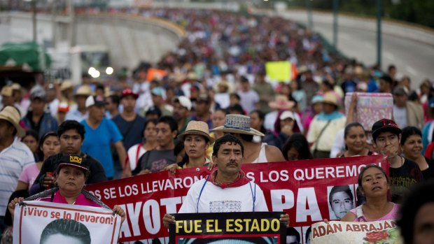 Relatives of the 43 missing Ayotzinapa teachers' college students lead a march on Saturday marking the one-year anniversary of the students' disappearances in Chilpancingo, Mexico