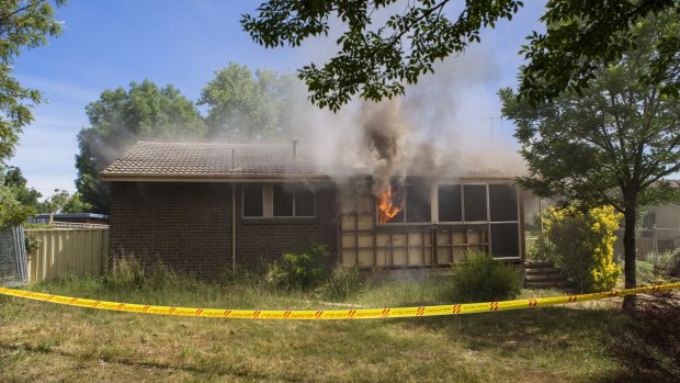 Hot property: Flames  billow from the windows of the Farrer house set alight for a training exercise.