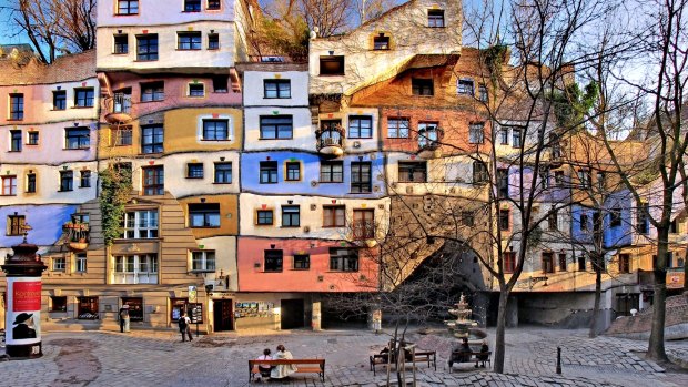 The central Hundredtwasserhaus apartment block with its colourful higgledy-piggledy façade revealing the influence Barcelona's Antoni Gaudi.

