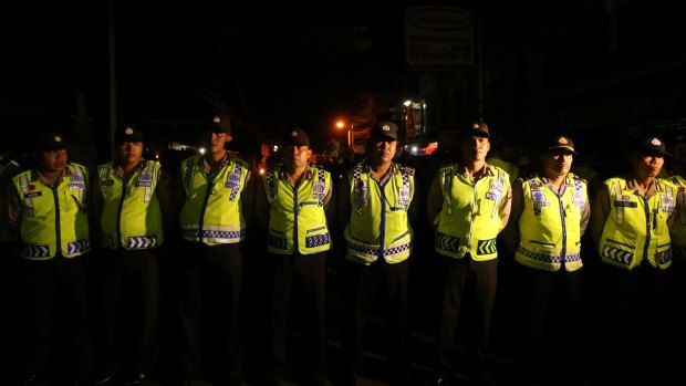 Indonesian police block the street near the entrance of Kerobokan prison where Bali nine duo Myuran Sukumaran and Andrew Chan will be transferred to Nusakambangan prison island for their executions.