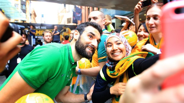 Socceroos captain Mile Jedinak helps fans capture the moment. 