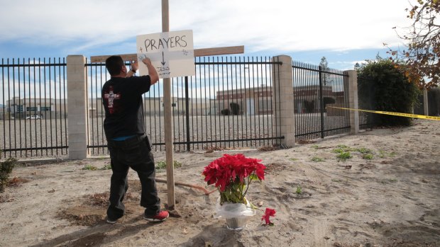 Erecting a cross and a sign near the site of a mass shooting on Wednesday in San Bernardino, California. 