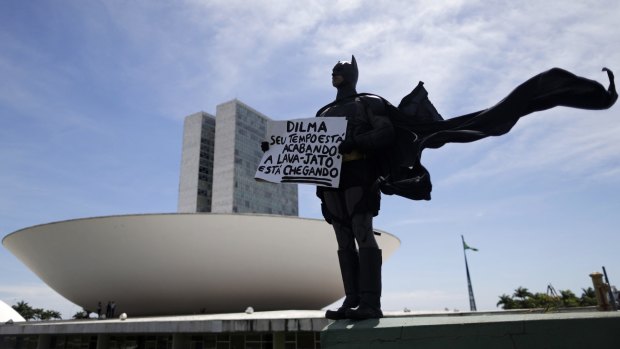An anti-government demonstrator dressed as Batman protests against corruption at the National Congress in Brasilia. 
