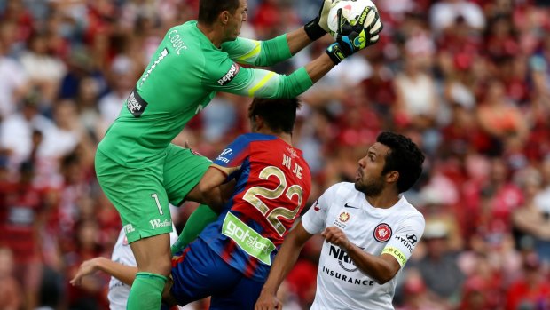Keeper's ball: Ante Covic climbs high to claim the ball over Jets player Kije Lee.