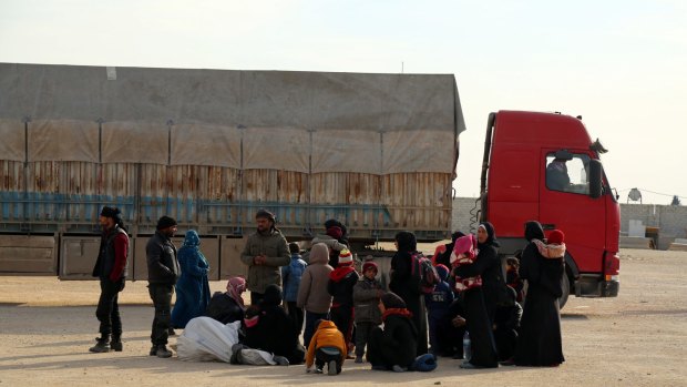 Syrians fleeing conflict in the Azaz region stand outside the Bab al-Salam border gate on Friday.