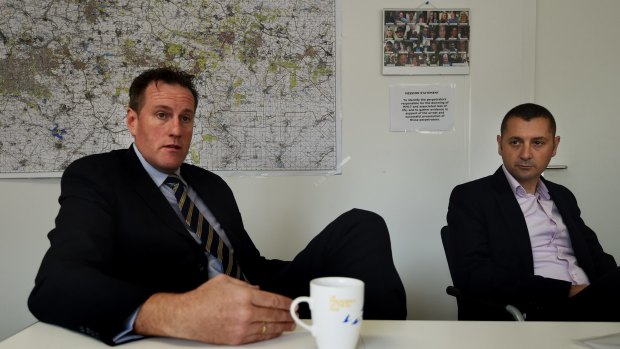 Andrew Donoghoe (left) with AFP Detective Sergeant Julian Bianco in the AFP's office at the Australian Embassy in The Hague. 