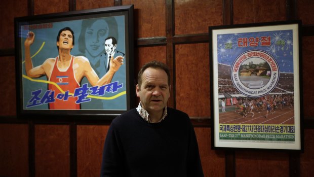 Nick Bonner, co-founder of Beijing-based Koryo Tours, with posters for the Pyongyang marathon.