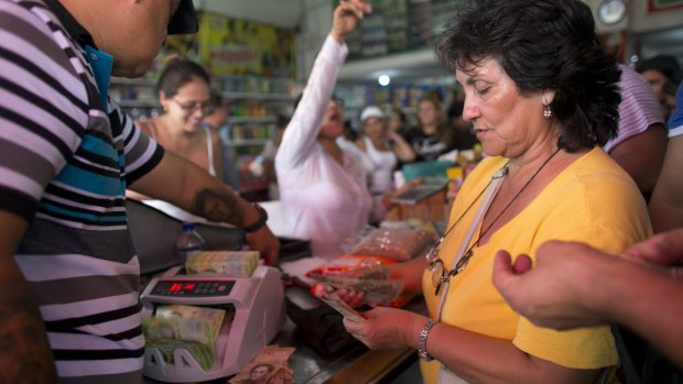 A woman pays for purchases in Venezuelan currency in a store in Cucuta, Colombia, on Sunday.