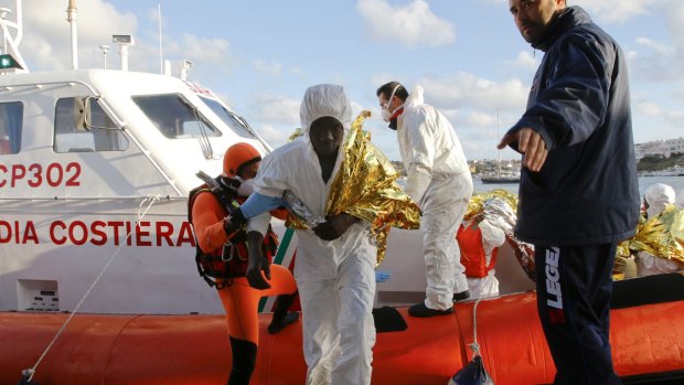 A survivor arrives at the Lampedusa harbour. Nine people were saved.