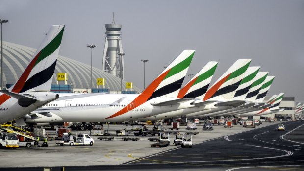 Emirates planes lined up at Dubai International Airport.