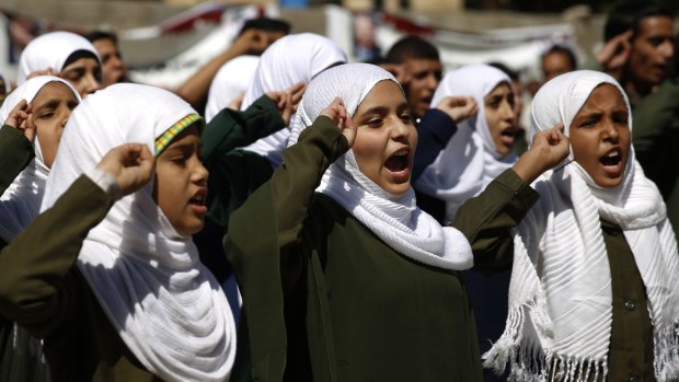 Yemeni students on Monday chant the national anthem at a protest in front of the UN in Sanaa to demand the Saudi-led coalition to stop targeting schools.
