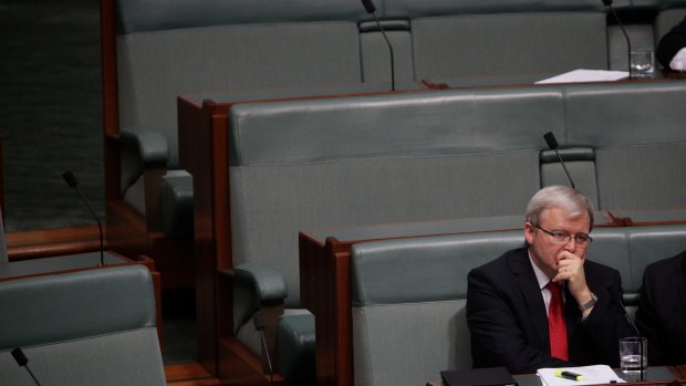 Labor MP Kevin Rudd sits on the backbench during Question Time at Parliament House after his demotion.